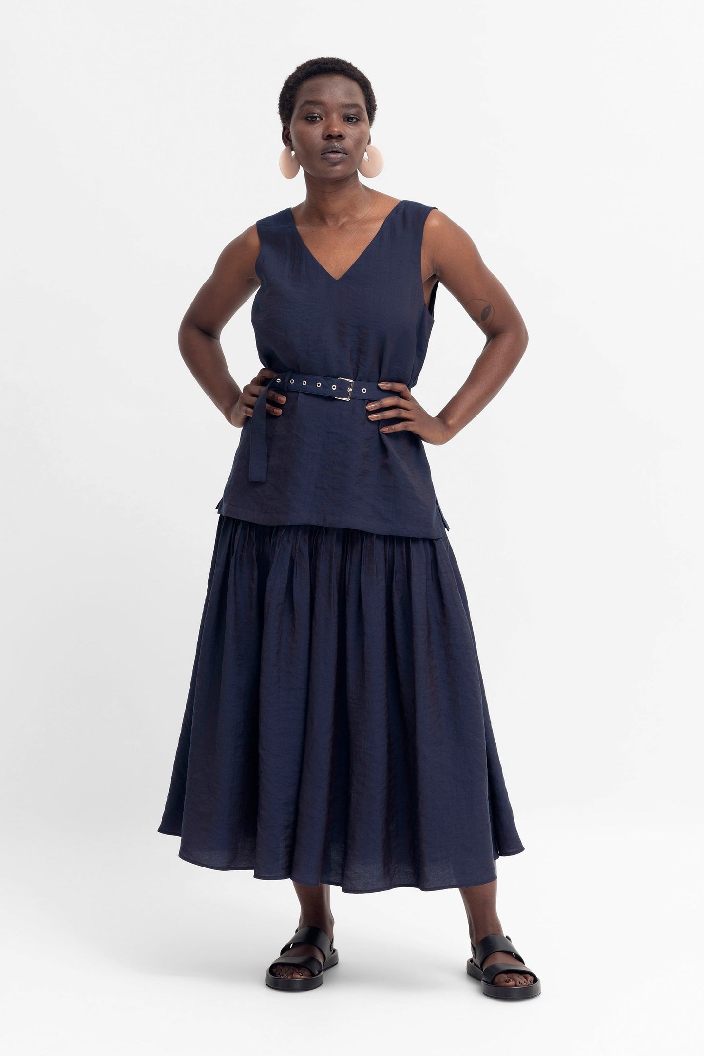 Glos Metallic Shine A-Line Knife Pleat Full Skirt Model Front with Glos Tank | NAVY SHINE